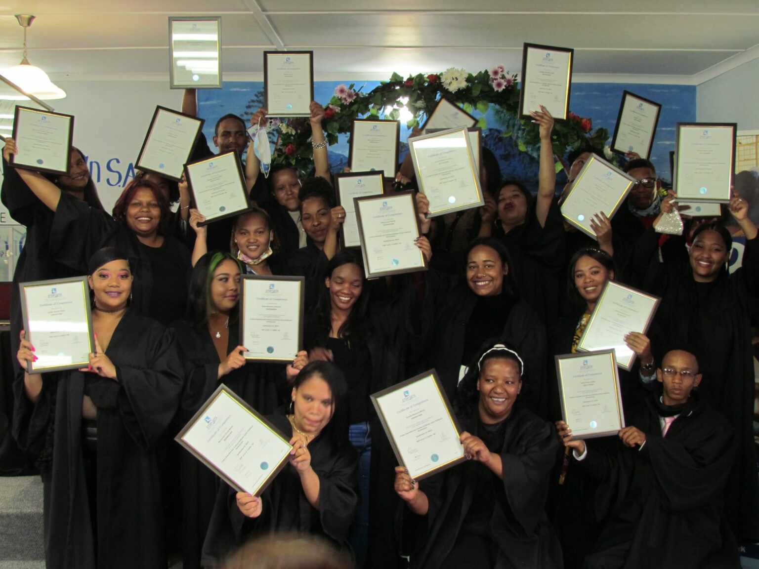 Graduates celebrating with their certificates